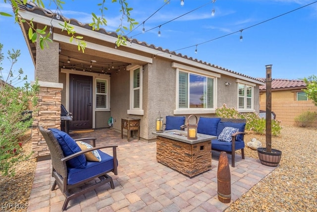view of patio / terrace featuring an outdoor fire pit