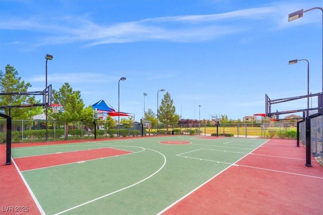 view of basketball court featuring fence and community basketball court