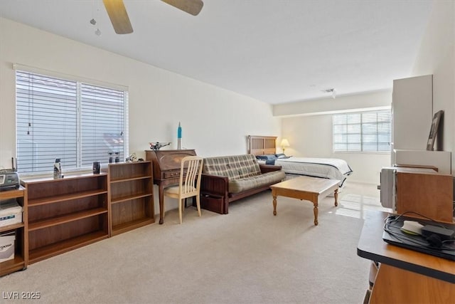 living area with ceiling fan and light colored carpet
