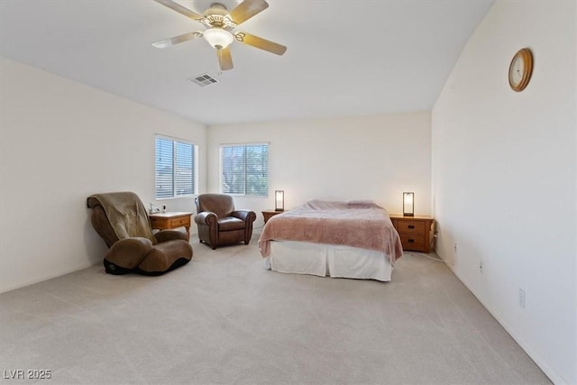 bedroom featuring light colored carpet, a ceiling fan, and visible vents