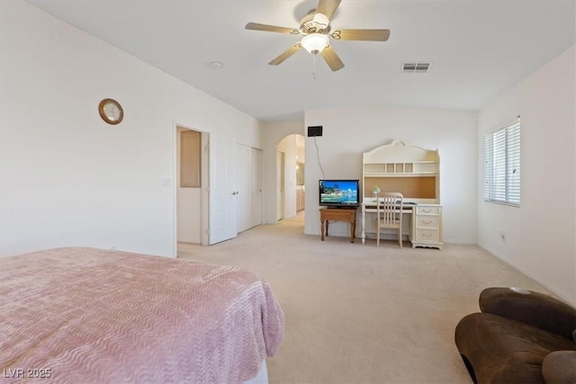 bedroom with arched walkways, light carpet, a ceiling fan, and visible vents