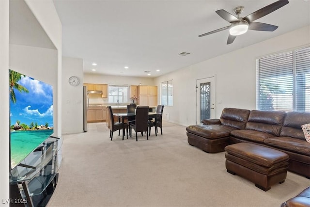 living area with recessed lighting, ceiling fan, light colored carpet, and visible vents