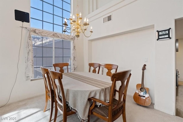 dining space featuring carpet floors, plenty of natural light, a notable chandelier, and visible vents
