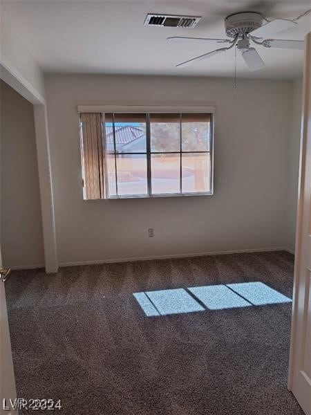 spare room featuring visible vents, carpet, ceiling fan, and baseboards