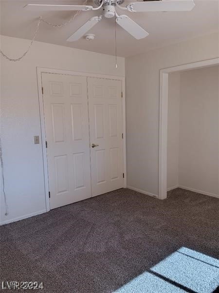 unfurnished bedroom with baseboards, carpet flooring, a ceiling fan, and a closet