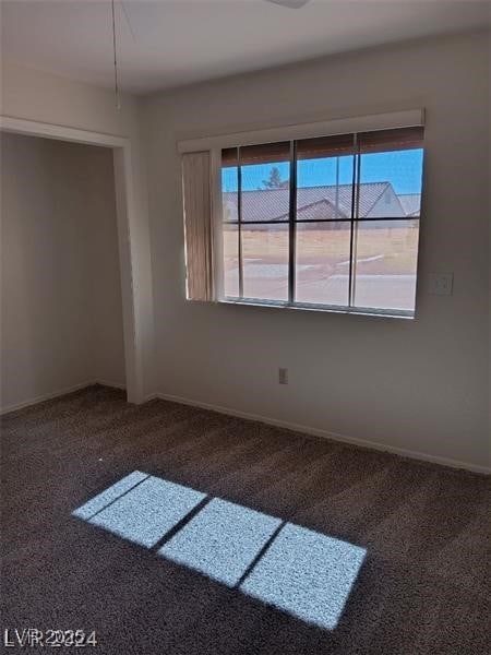 carpeted spare room with baseboards