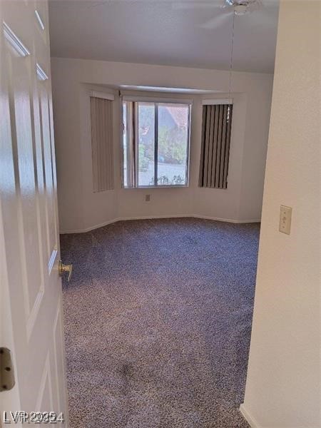 carpeted spare room featuring baseboards