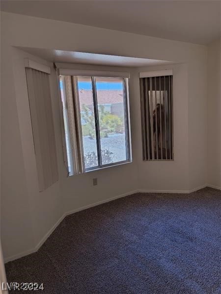 empty room with carpet floors and baseboards