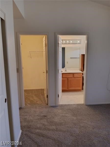 corridor with light colored carpet and baseboards