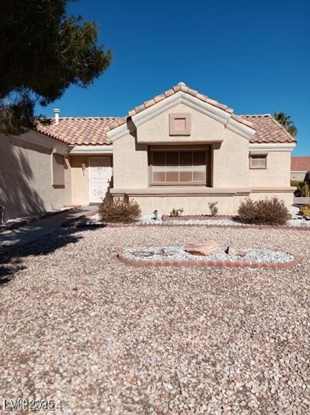 view of front of home with stucco siding and a tile roof