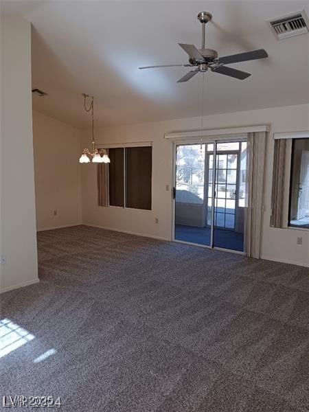 carpeted empty room with baseboards, ceiling fan with notable chandelier, lofted ceiling, and visible vents