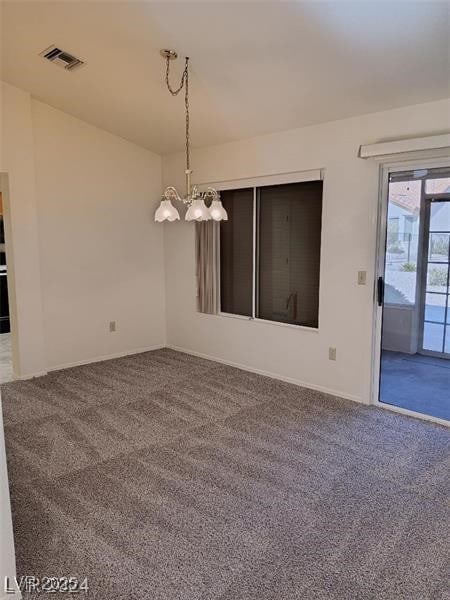 carpeted empty room with visible vents, baseboards, and an inviting chandelier
