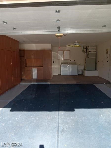 garage featuring heating unit and washer and clothes dryer