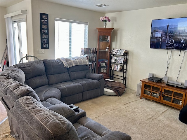 carpeted living area with visible vents