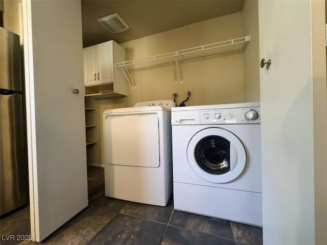 2750 S Durango Dr Unit 1038, Las Vegas, NV 89117 - washroom with washing machine and clothes dryer, visible vents, stone finish floor, and cabinet space