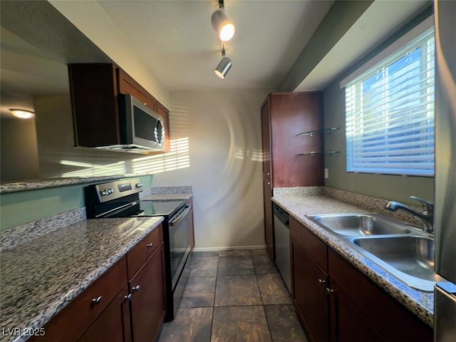 2750 S Durango Dr Unit 1038, Las Vegas, NV 89117 - kitchen featuring baseboards, a sink, appliances with stainless steel finishes, and stone finish floor