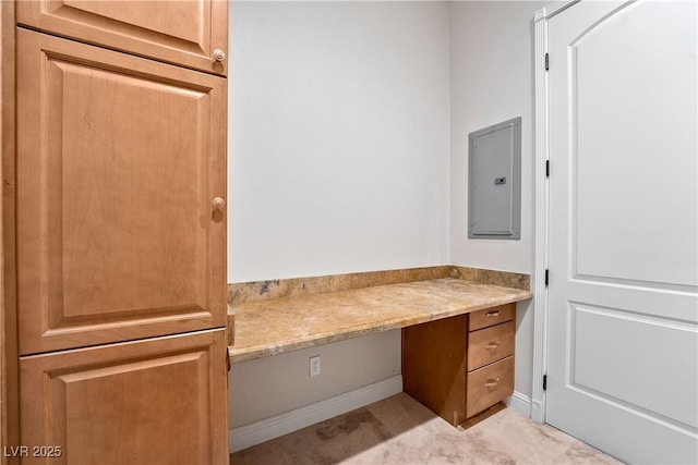 bathroom with baseboards and electric panel