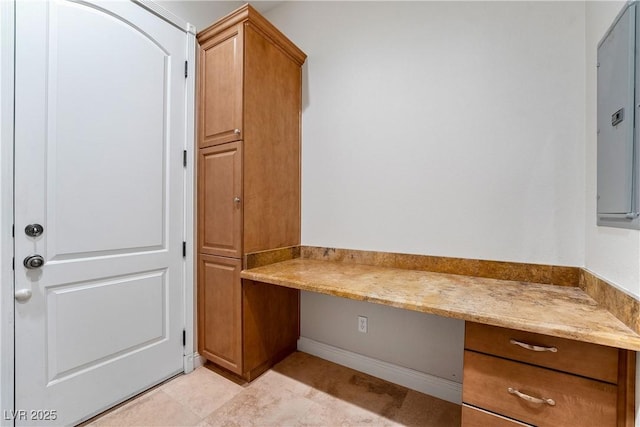 unfurnished office with built in desk and electric panel