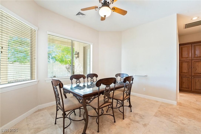 dining space featuring visible vents, baseboards, ceiling fan, and light tile patterned floors