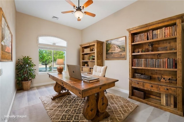 office featuring baseboards, ceiling fan, and visible vents