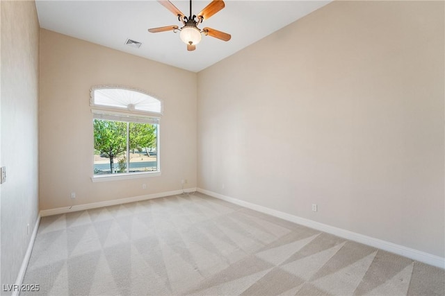 unfurnished room featuring light colored carpet, baseboards, visible vents, and a ceiling fan