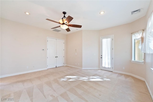 unfurnished bedroom featuring recessed lighting, baseboards, visible vents, and light carpet