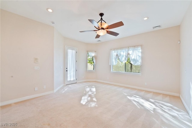 unfurnished room with baseboards, light carpet, and recessed lighting