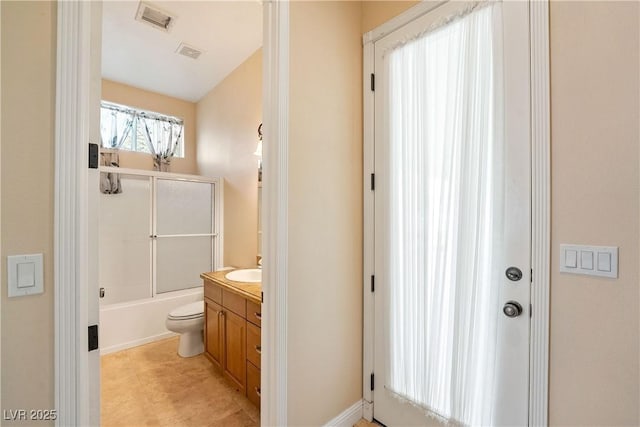 full bathroom featuring toilet, visible vents, combined bath / shower with glass door, and vanity