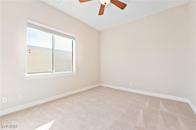 unfurnished room with baseboards, a ceiling fan, and light carpet