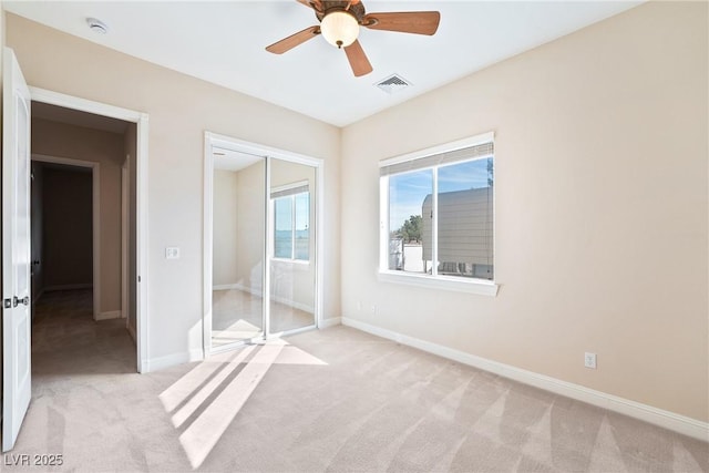 unfurnished bedroom with visible vents, baseboards, ceiling fan, and light carpet