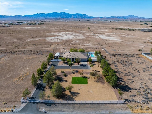 drone / aerial view featuring a desert view, a mountain view, and a rural view