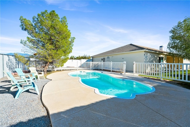 view of swimming pool with a patio, fence, and a fenced in pool