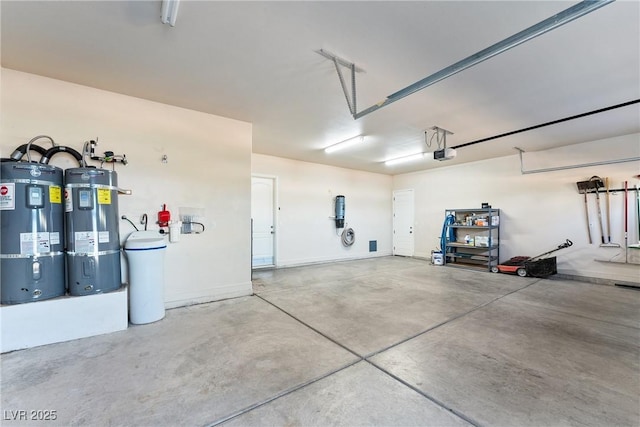 garage featuring water heater, a garage door opener, and electric water heater