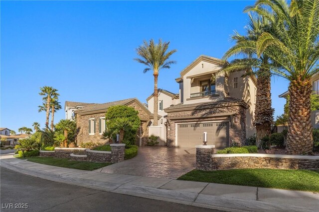1911 Alcova Ridge Dr, Las Vegas, NV 89135 - view of front facade with stone siding, a garage, stucco siding, a balcony, and driveway