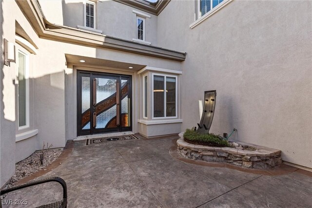 1911 Alcova Ridge Dr, Las Vegas, NV 89135 - doorway to property featuring stucco siding and a patio area