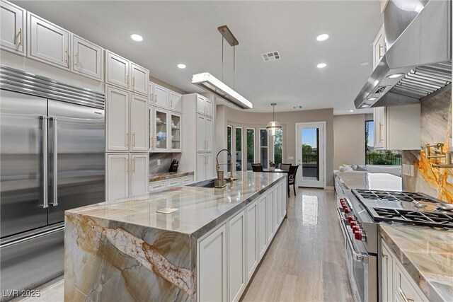 1911 Alcova Ridge Dr, Las Vegas, NV 89135 - kitchen with wall chimney range hood, premium appliances, recessed lighting, and a sink