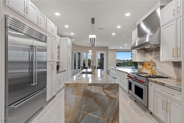 1911 Alcova Ridge Dr, Las Vegas, NV 89135 - kitchen with a sink, white cabinets, wall chimney range hood, and high quality appliances