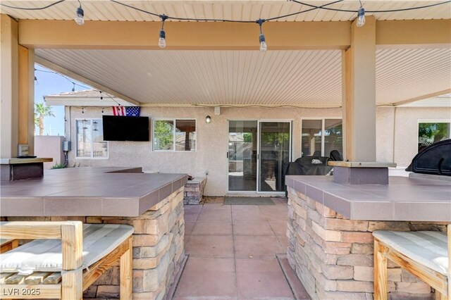 view of patio / terrace with outdoor wet bar and area for grilling