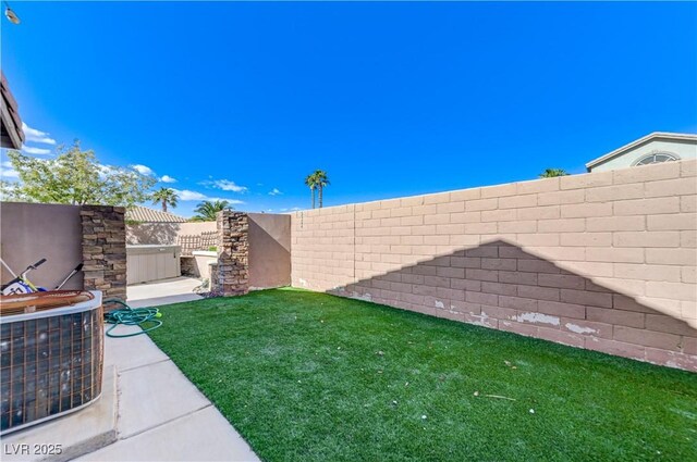 view of yard featuring a fenced backyard and central AC unit