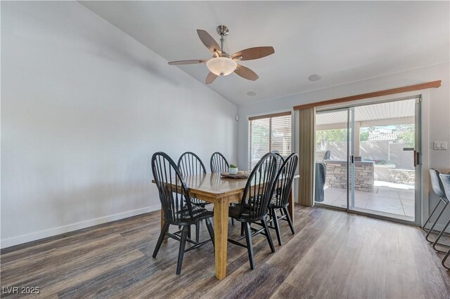 dining room featuring a ceiling fan, baseboards, wood finished floors, and lofted ceiling
