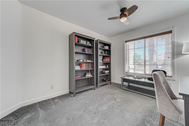 carpeted home office with baseboards and ceiling fan