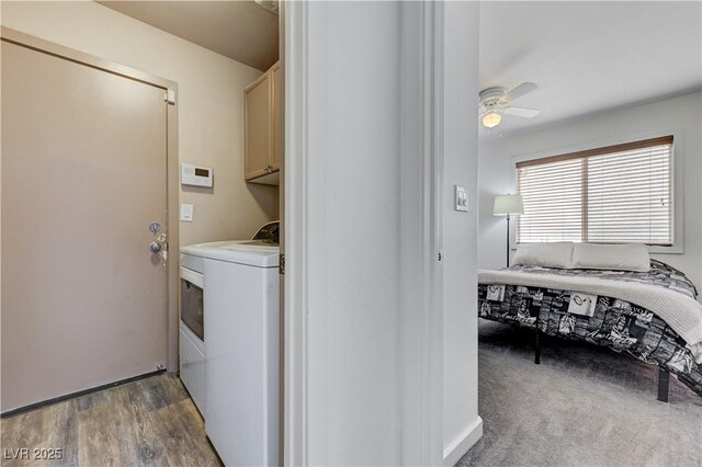 clothes washing area featuring washer / dryer, a ceiling fan, cabinet space, and wood finished floors