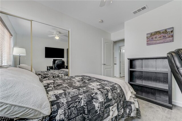 bedroom with carpet floors, ceiling fan, a closet, and visible vents