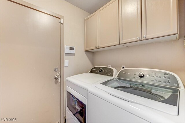 washroom with cabinet space and separate washer and dryer