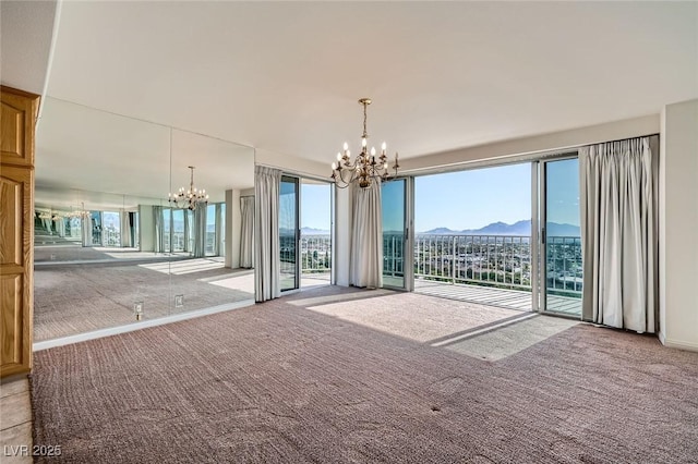 3111 Bel Air Dr Unit 18B, Las Vegas, NV 89109 - carpeted empty room featuring an inviting chandelier, a mountain view, and a healthy amount of sunlight