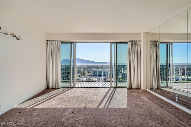 3111 Bel Air Dr Unit 18B, Las Vegas, NV 89109 - carpeted spare room featuring a mountain view