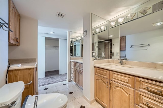 3111 Bel Air Dr Unit 18B, Las Vegas, NV 89109 - bathroom featuring visible vents, tile patterned flooring, two vanities, a shower stall, and a sink