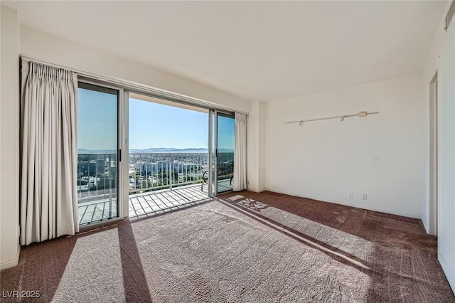 3111 Bel Air Dr Unit 18B, Las Vegas, NV 89109 - carpeted spare room with a mountain view