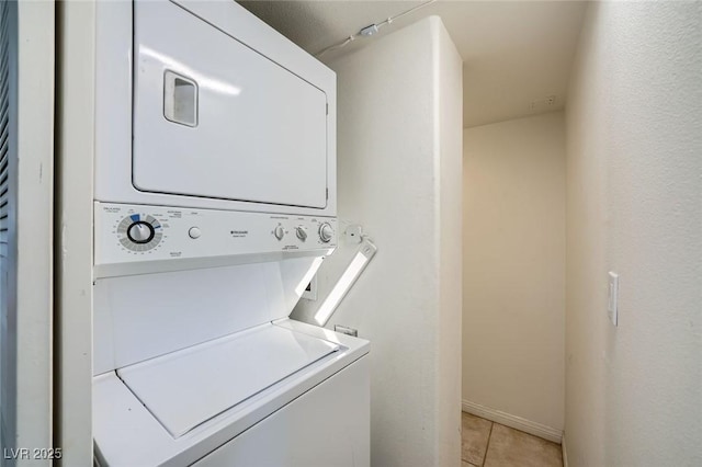 3111 Bel Air Dr Unit 18B, Las Vegas, NV 89109 - washroom with light tile patterned floors, laundry area, and stacked washer / dryer