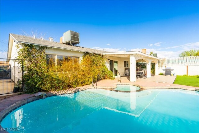 4471 Wisconsin Ave, Las Vegas, NV 89104 - back of property with fence, a patio, a pool with connected hot tub, and central AC